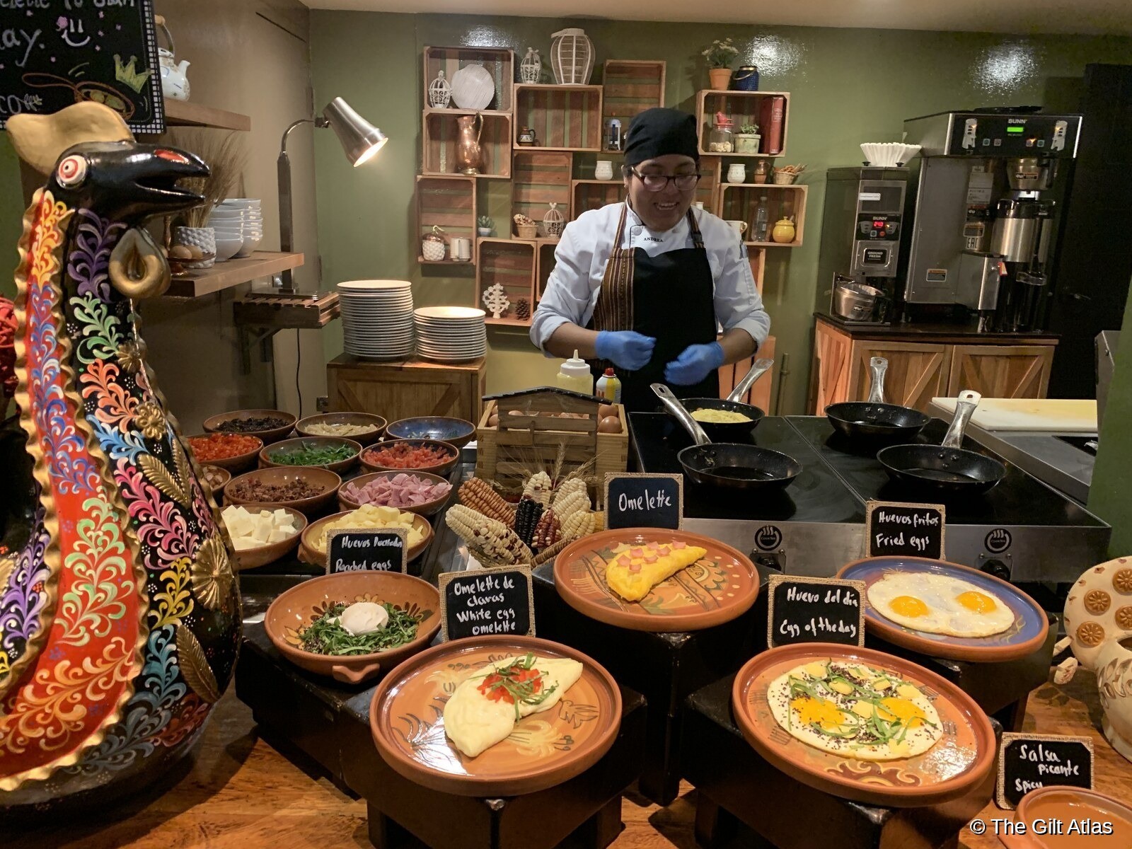 JW Marriott Cusco breakfast egg station with chef, terracotta bowls and Peruvian bird sculpture