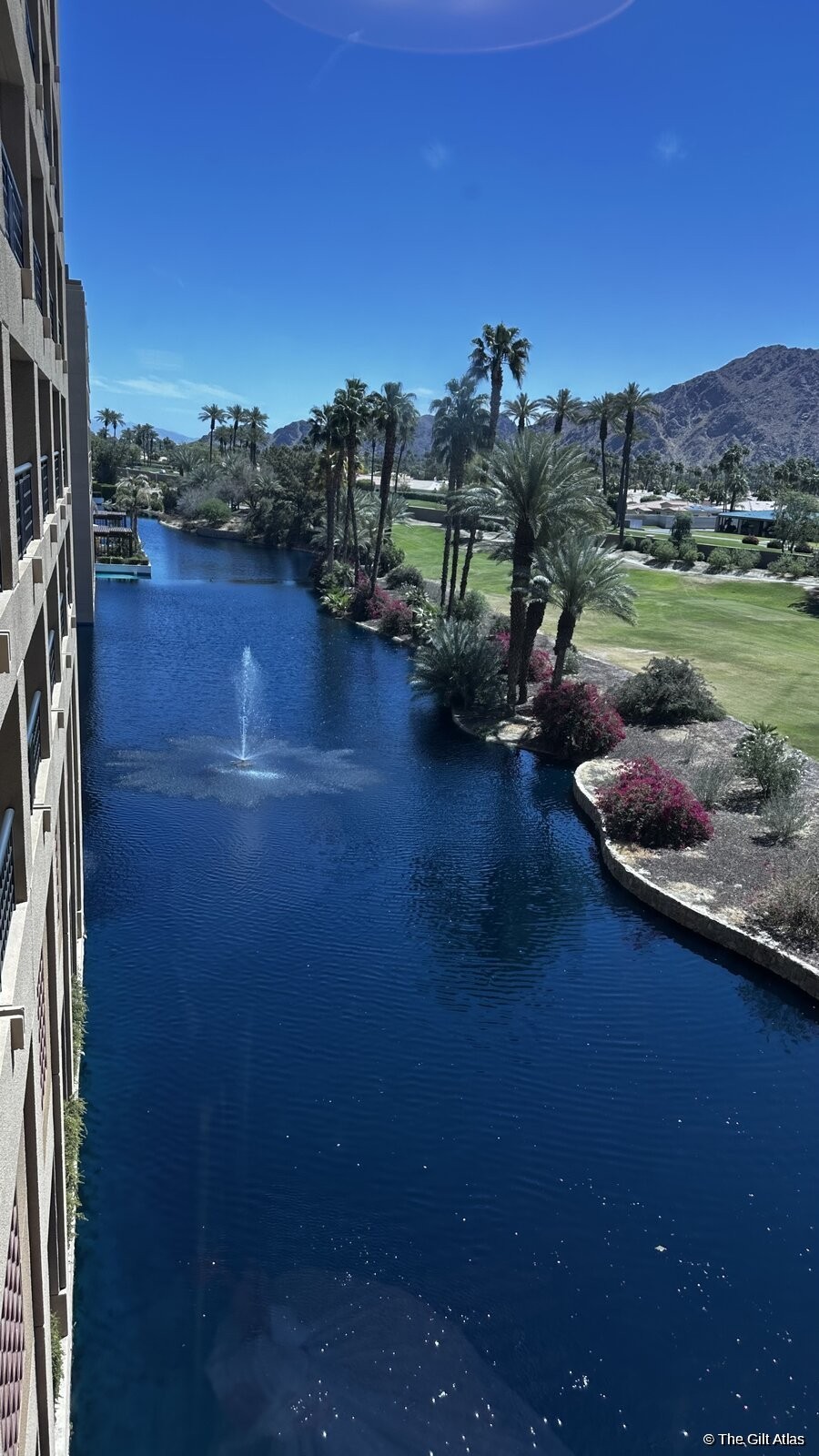 View from a guest room balcony over the resort lagoon and desert landscape
