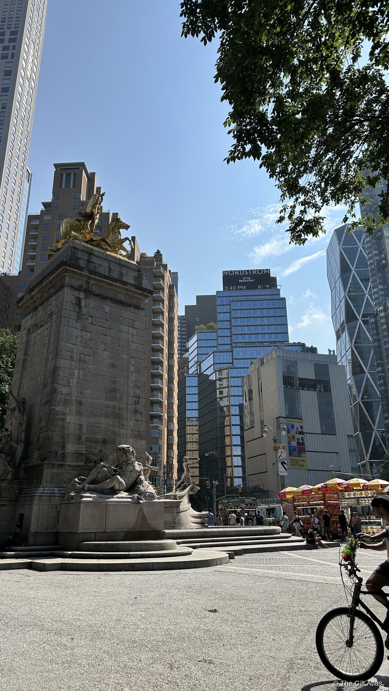 Columbus Circle monument with golden statue, NYC skyline behind
