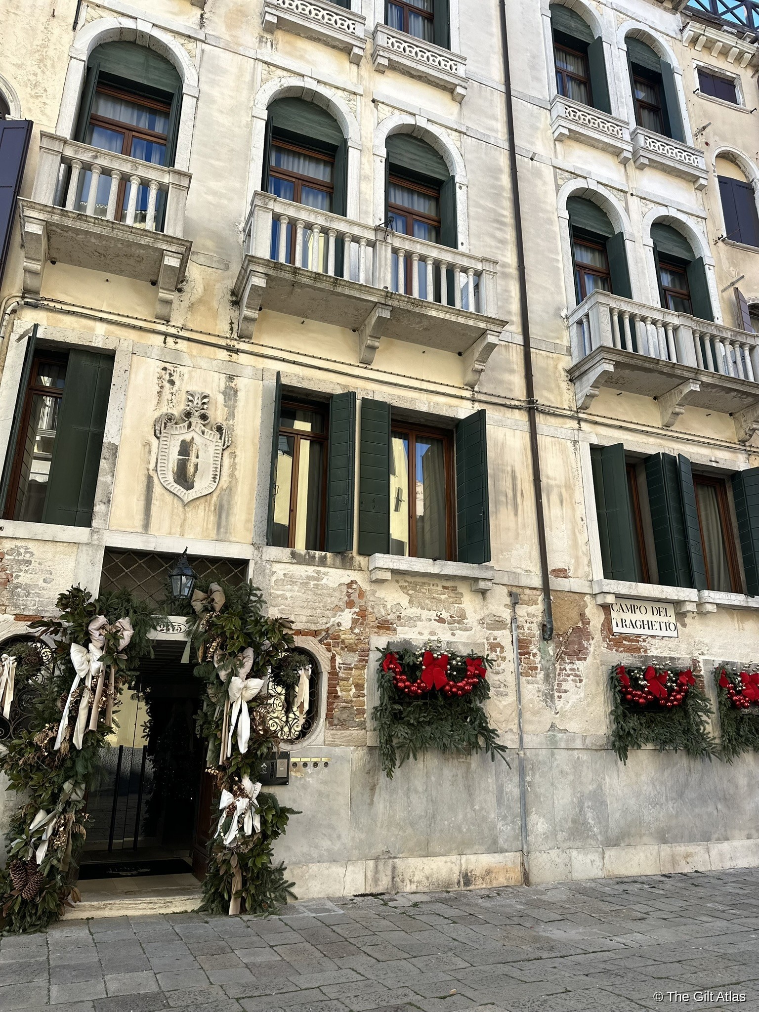 The Gritti Palace facade on Campo Santa Maria del Giglio, dressed with Christmas wreaths at the entrance