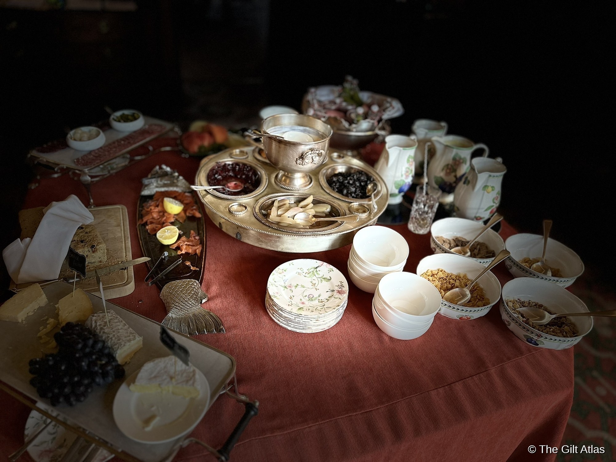 The castle breakfast table at Inverlochy — silver serving pieces, fine china, and a spread that signals the calibre of the house immediately.