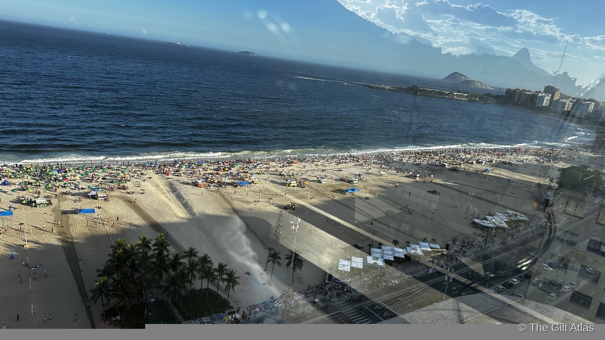 Copacabana beach viewed from room — morning light, long shadows across the sand