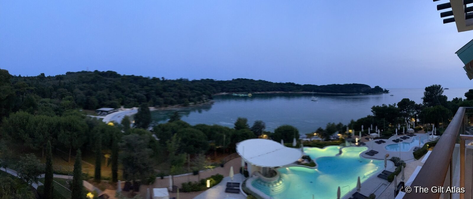 The Monti Mulini pool and grounds, with Rovinj's old town visible across the bay
