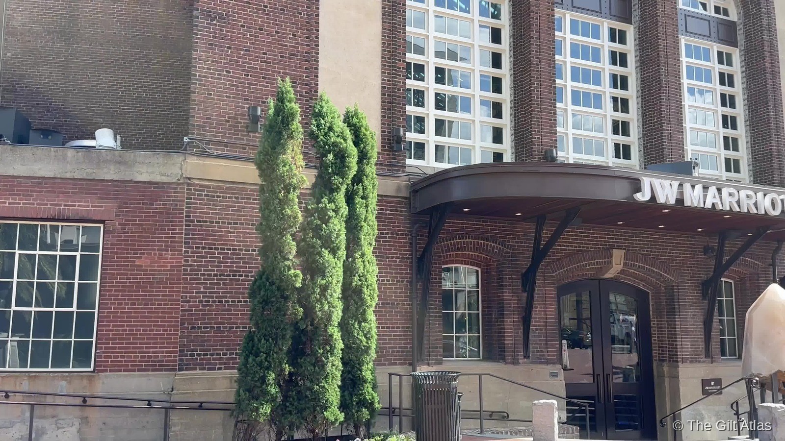 The JW Marriott Savannah Plant Riverside District entrance — the historic brick power plant facade with the hotel signage above the arched doorway