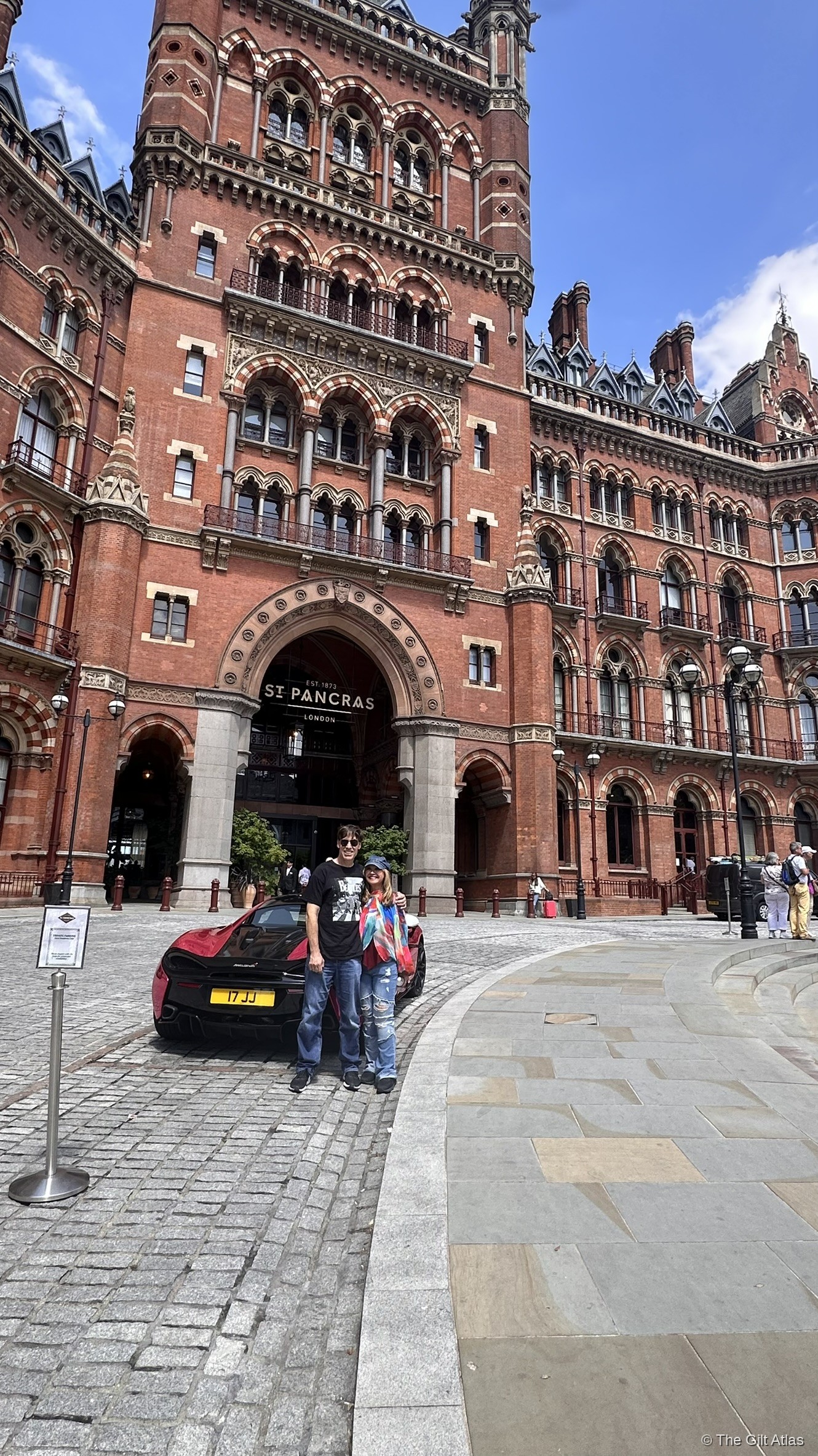 The St. Pancras Renaissance Hotel entrance arch on the Euston Road forecourt, with the Gothic facade rising above.