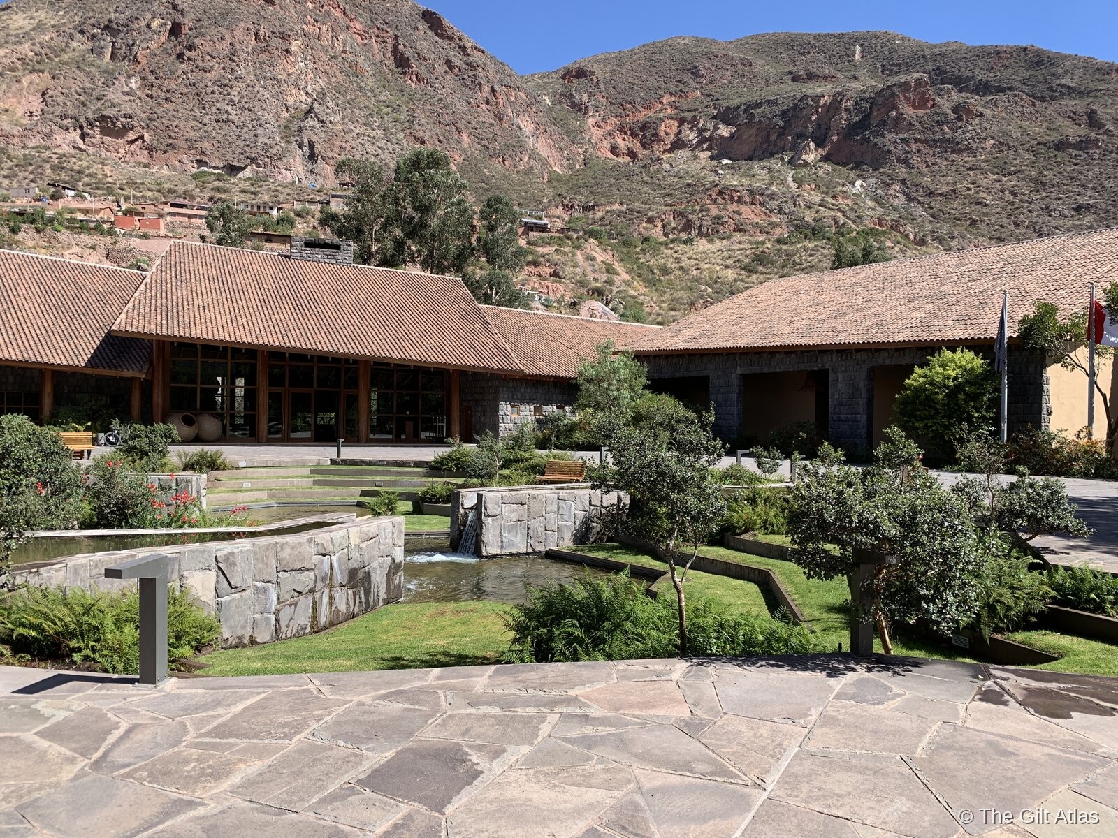 Tambo del Inka exterior with Andean peaks rising behind the property