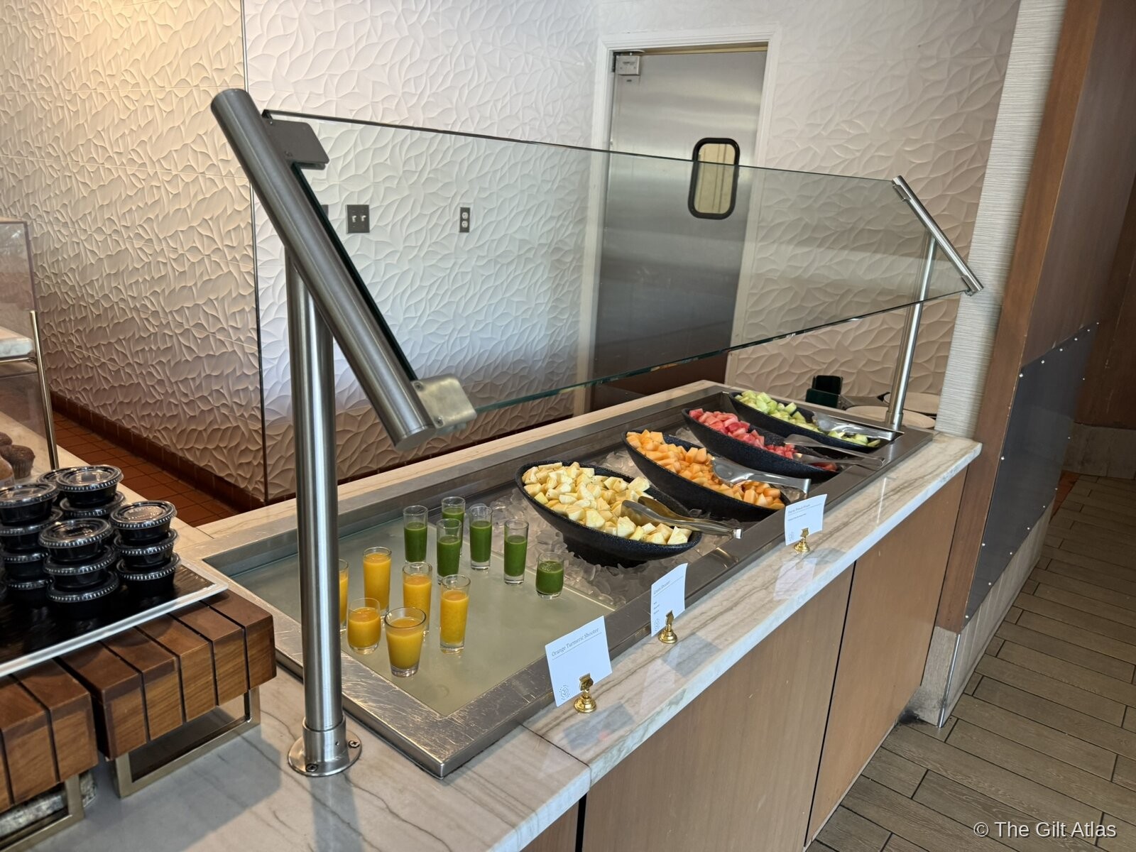 Westin San Diego Bayview breakfast buffet — fresh juice shots in orange and green, bowls of cut fruit on ice